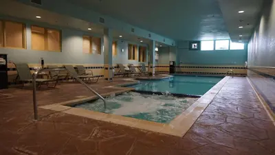 a large swimming pool in the middle of a building at Candlewood Suites-West Springfield by IHG in West Springfield