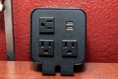 a black electrical outlet on a red wall at Red Roof Inn Meriden - CT in Meriden