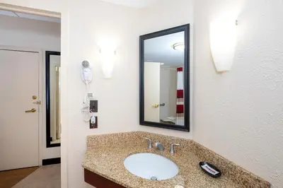 a bathroom with a sink and a mirror at Red Roof Inn Meriden - CT in Meriden