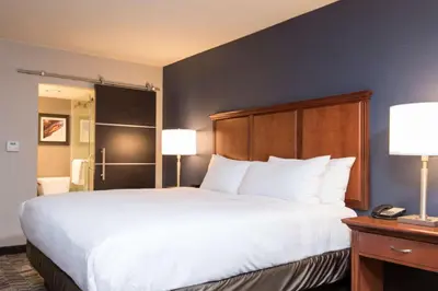 a large bed in a hotel room with two lamps at DoubleTree by Hilton Schenectady in Schenectady