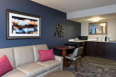 a living room with a couch and a table at DoubleTree by Hilton Schenectady in Schenectady