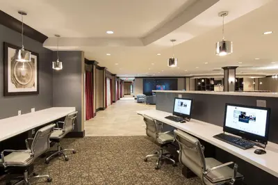 an office with a desk with a computer on it at DoubleTree by Hilton Schenectady in Schenectady