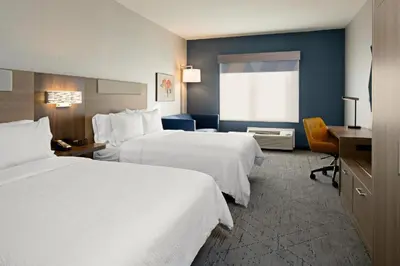 a hotel room with two beds and a desk at Holiday Inn Express & Suites Albany Airport Area - Latham by IHG in Latham