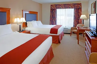 a hotel room with two beds and a flat screen tv at Holiday Inn Express & Suites Albany Airport Area - Latham by IHG in Latham