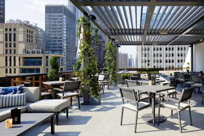 a patio with tables and chairs on a building at The Peninsula New York in New York