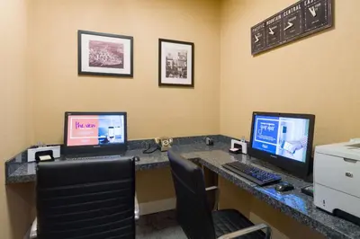 an office with two computer monitors on a desk at Hampton Inn Manhattan - Times Square South in New York