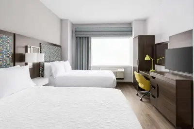 a hotel room with two beds and a television at Hampton Inn Manhattan-35th St Empire State Bldg in New York