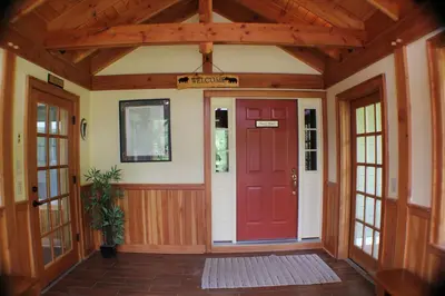 a hallway with a red door in a house at The Inn at Quail Run in Wilmington