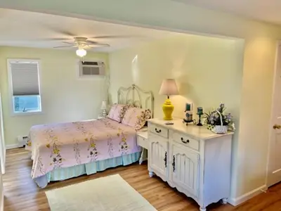 a bedroom with a bed and a table with a lamp at The Inn at Quail Run in Wilmington