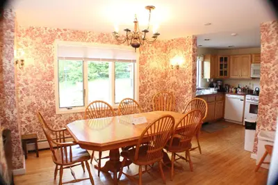 a dining room with a wooden table and chairs at The Inn at Quail Run in Wilmington