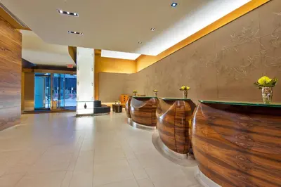 a lobby with a row of wooden bar stools at Hilton Club West 57th Street New York in New York