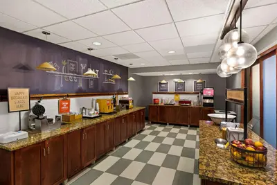 a fast food restaurant with a counter and a cafeteria at Hampton Inn & Suites Poughkeepsie in Spackenkill