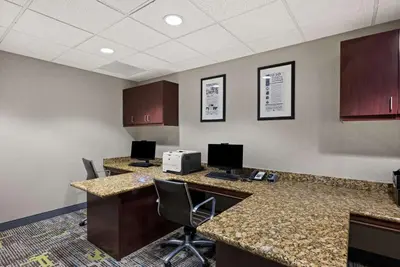 an office with two desks with computers and chairs at Hampton Inn & Suites Poughkeepsie in Spackenkill