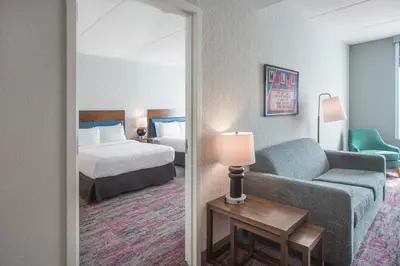 a hotel room with a bed and a couch at Home2 Suites by Hilton Saratoga Malta in Malta
