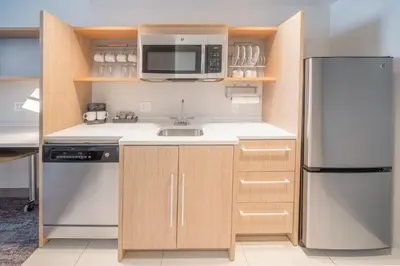 a kitchen with a sink and a refrigerator at Home2 Suites by Hilton Saratoga Malta in Malta