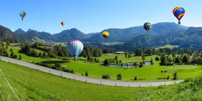 a group of hot air balloons flying over a field at Holiday Inn Binghamton-Downtown Hawley Street by IHG in Binghamton