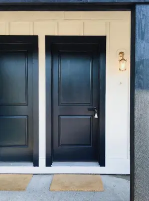 two black doors on the side of a building at Brentwood Hotel in Saratoga Springs