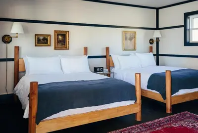 two beds in a room with at Brentwood Hotel in Saratoga Springs