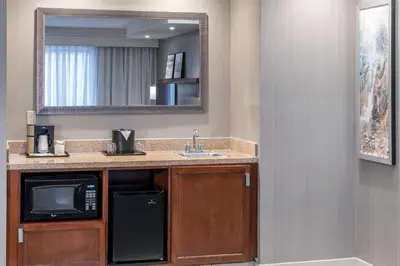 a kitchen with a sink and a microwave at Courtyard by Marriott West Orange in West Orange