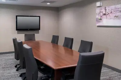 a conference room with a wooden table and chairs at Courtyard by Marriott West Orange in West Orange