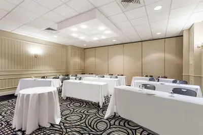 a conference room with white tables and chairs at Wyndham Southbury in Southbury