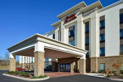 a hotel building with a sign on it at Hampton Inn & Suites Albany-East Greenbush, NY in East Greenbush