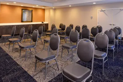 a conference room with chairs and a podium at Hampton Inn & Suites Albany-East Greenbush, NY in East Greenbush