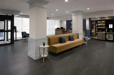 a lobby with a couch and tables in a library at Courtyard New Haven at Yale in New Haven