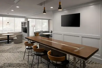 a conference room with a table and a tv on a wall at Courtyard New Haven at Yale in New Haven