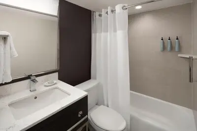 a bathroom with a sink and a toilet and a shower at Courtyard New Haven at Yale in New Haven