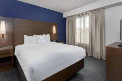a hotel room with a large bed and a window at Residence Inn Wayne in Wayne