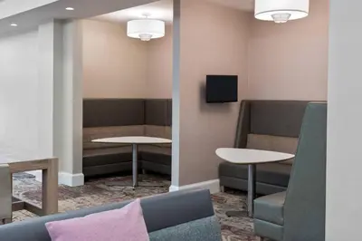 a waiting room with two tables and a tv at Residence Inn Wayne in Wayne
