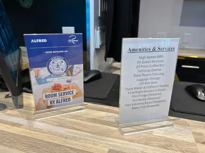 two signs sitting on top of a wooden table at Hotel Richland LES in New York