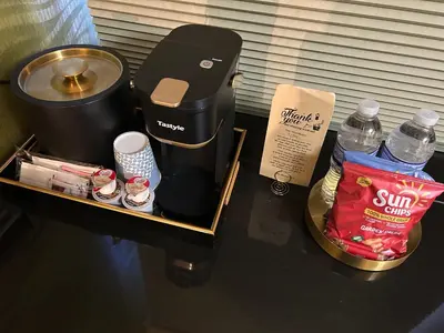 a table with a coffee maker and a bottle of water at Hotel Richland LES in New York