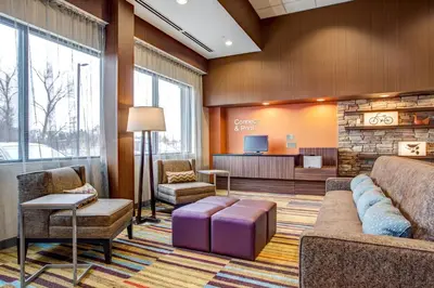 a lobby with a waiting room with a couch and chairs at Fairfield Inn & Suites by Marriott Springfield Holyoke in Holyoke