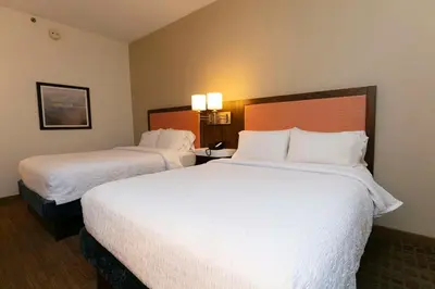 two beds in a hotel room with white sheets at Hampton Inn Scranton at Montage Mountain in Scranton