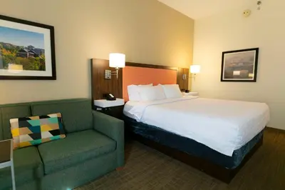 a hotel room with a bed and a chair at Hampton Inn Scranton at Montage Mountain in Scranton