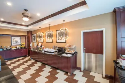 a restaurant with a food counter in a room at Hampton Inn Kingston in Kingston