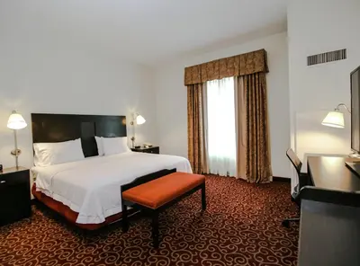 a hotel room with a bed and a window at Hampton Inn Kingston in Kingston