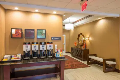 a waiting room at a hospital with a counter with alcohol bottles at Hampton Inn Kingston in Kingston