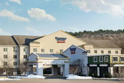 a large white building with snow in front of it at Fairfield Inn and Suites by Marriott Plainville in Plainville