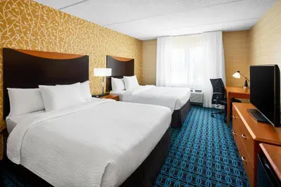 a hotel room with two beds and a television at Fairfield Inn and Suites by Marriott Plainville in Plainville