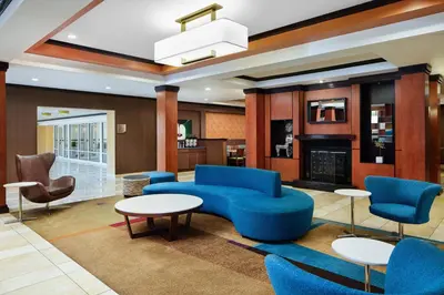 a lobby with blue furniture and a fireplace at Fairfield Inn and Suites by Marriott Plainville in Plainville