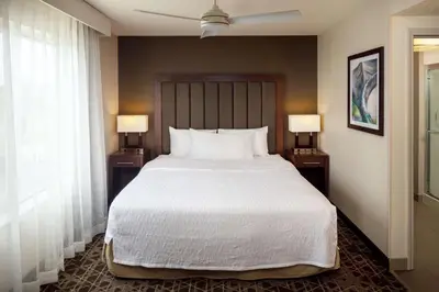 a bedroom with a large bed and two night stands with lamps at Homewood Suites by Hilton Wallingford-Meriden in Wallingford