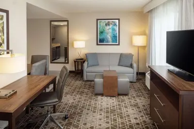 a living room with a couch and a television at Homewood Suites by Hilton Wallingford-Meriden in Wallingford