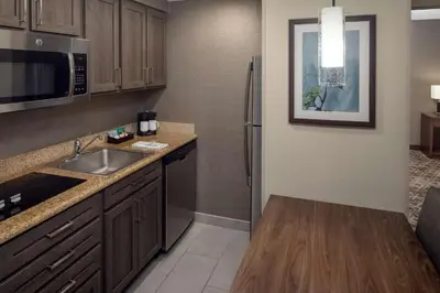a kitchen with a sink and a refrigerator at Homewood Suites by Hilton Wallingford-Meriden in Wallingford