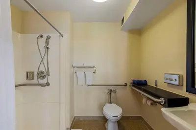 a bathroom with a toilet and a sink and a shower at The Capitol Hotel in Hartford