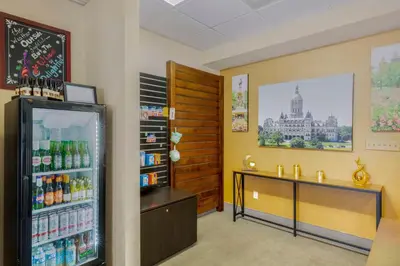 a store with a refrigerator and a shelf of drinks at The Capitol Hotel in Hartford