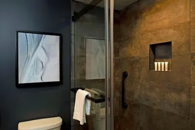 a bathroom with a toilet and a glass shower at The Lloyd Stamford, Tapestry Collection by Hilton in Stamford