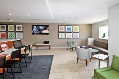 a waiting room with a couch and a table at Holiday Inn Express Branford-New Haven by IHG in Branford